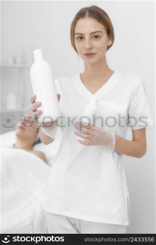 beautician with lotion female client 2