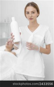 beautician with lotion female client 2