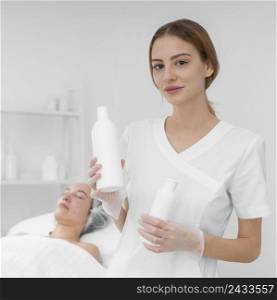 beautician with lotion female client