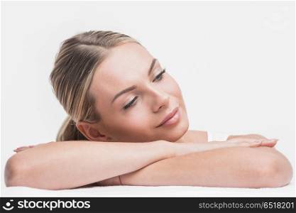 Beautifil woman holding head on hands. Beautiful sensual woman holding head on stacked hands. Beauty and skincare concept. Isolated over white.