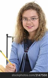 Beautiful 12 year old girl holding pencil. Curly blonde hair and glasses.