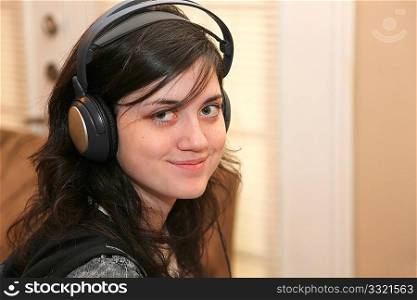 Beautiful 15 year old girl wearing headphones.