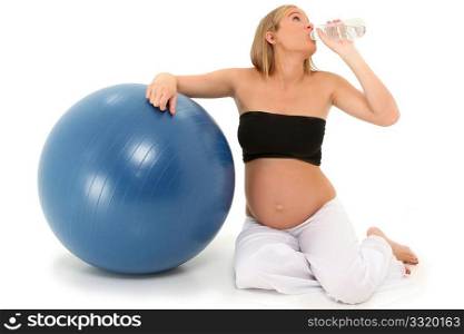 Beautiful 19 year old pregnant mother-to-be after workout drinking water over white background.