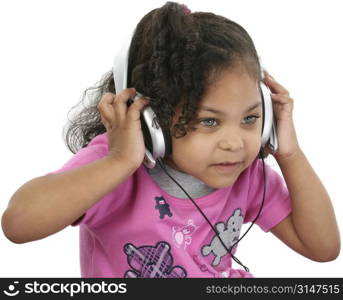 Beautiful 3 year old girl listening to headphones.