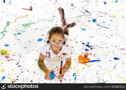 Beautiful 6 year old girl covered in colorful paint.
