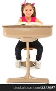 Beautiful 7 year old american girl sitting in school desk over white background.
