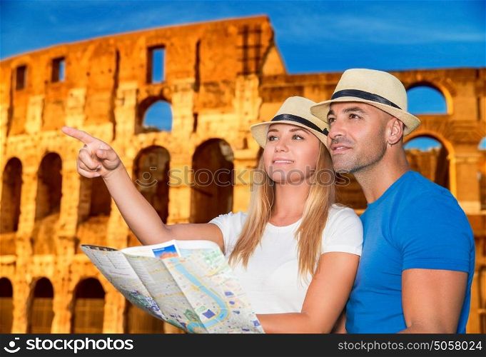 Beautiful active couple with map standing on Coliseum background and looking for right way, travel to Rome and exploring it by themself, Italy Europe