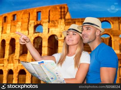 Beautiful active couple with map standing on Coliseum background and looking for right way, travel to Rome and exploring it by themself, Italy Europe
