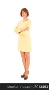 Beautiful adult woman in yellow dress and high heels smiling at camera. Isolated, studio shot.