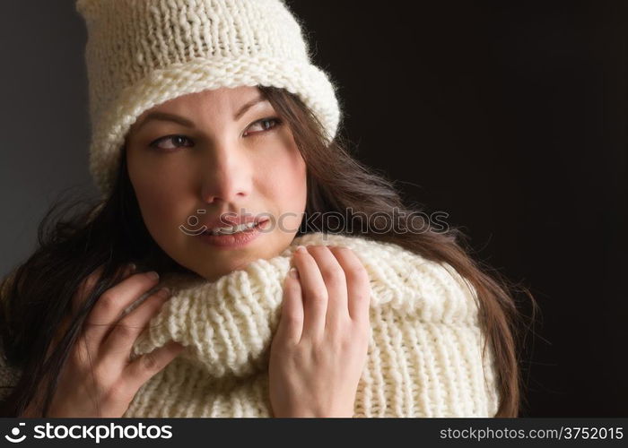 Beautiful adult woman wearing knitted wear, gray background