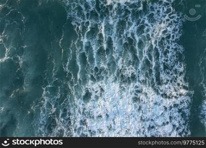 Beautiful aerial drone landscape top down view of wave detail in jade colored receding waves