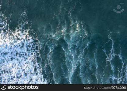 Beautiful aerial drone landscape top down view of wave detail in jade colored receding waves