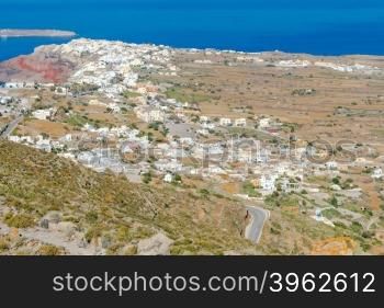 Beautiful aerial view of the white houses of the famous village Oia from the top of the mountain.. Oia. Aerial view from above.