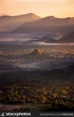 Beautiful aerial view sea of fog in the morning forest mountent with green mountains. Pang Puai, Mae Moh, Lampang, Thailand.. Aerial view Fog in forest.