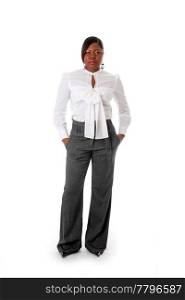 Beautiful African American business woman with attitude dressed in a white shirt and gray pants standing, hands in pocket, isolated