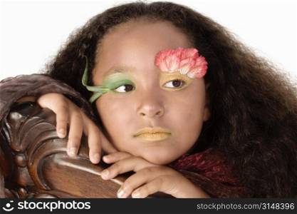 Beautiful African American girl decorated with carnations and face paint.
