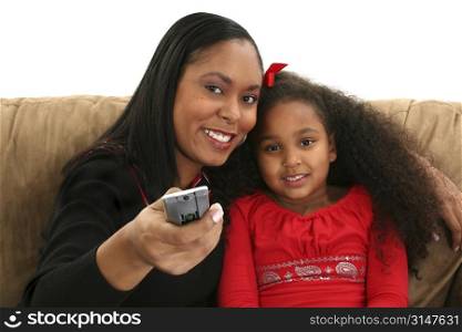 Beautiful African American woman and child with TV remote control