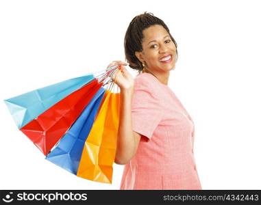 Beautiful African-american woman holding a handful of shopping bags. Isolated on white.