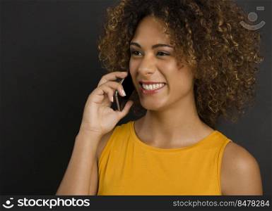 Beautiful African American woman making a phone call and laughing