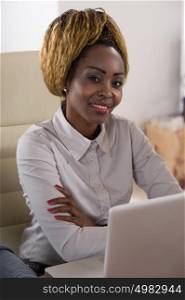 Beautiful african business woman working at office using laptop