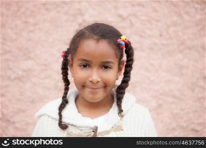 Beautiful african child with a brick a pink wall of background