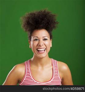 Beautiful African woman laughing over a green background