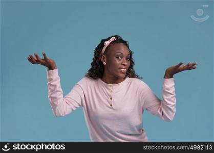 Beautiful African woman making a scale with her arms wide open on blue background