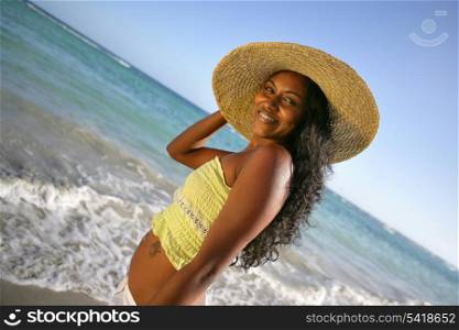 beautiful African woman walking on the beach