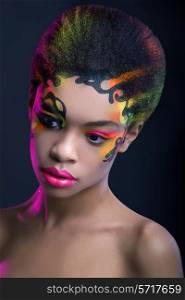 Beautiful african woman with creative neon make up on dark blue background