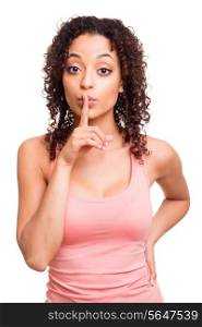 beautiful african woman with finger in front of her mouth asking for silence over white background
