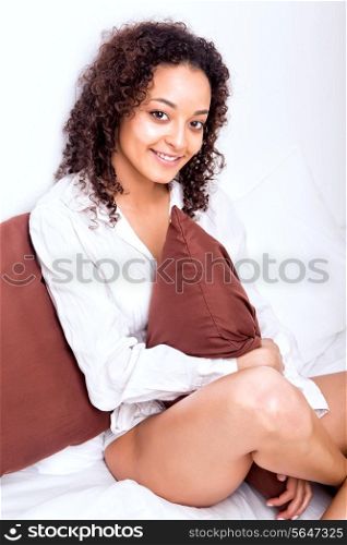 Beautiful afro woman at home relaxing in bed