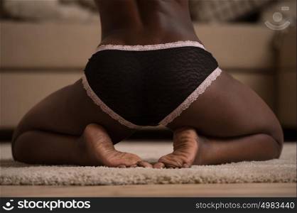 Beautiful alluring african woman in sexy lingerie. Portrait of beautiful sexy stylish young woman model with perfect clean skin in black lingerie ass closeup