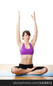 Beautiful and athletic young woman doing yoga exercises
