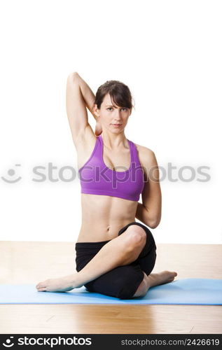 Beautiful and athletic young woman doing yoga exercises