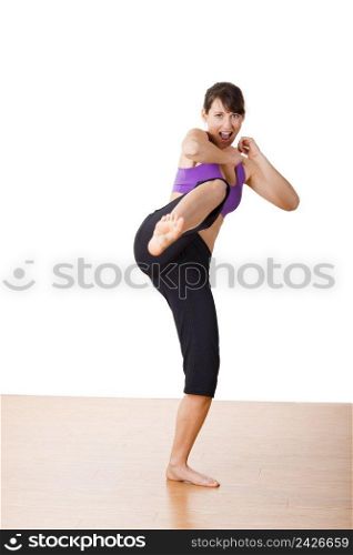 Beautiful and athletic young woman practicing karate 