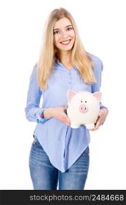 Beautiful and attractive blonde woman holding a piggy bank, isolated over white background