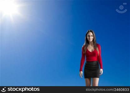 Beautiful and attractive woman against a beautiful blue sky