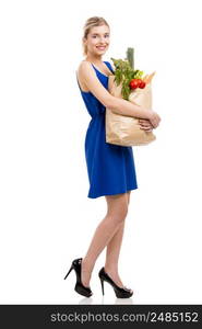 Beautiful and attractive woman carrying a bag full of vegetables, isolated over white background