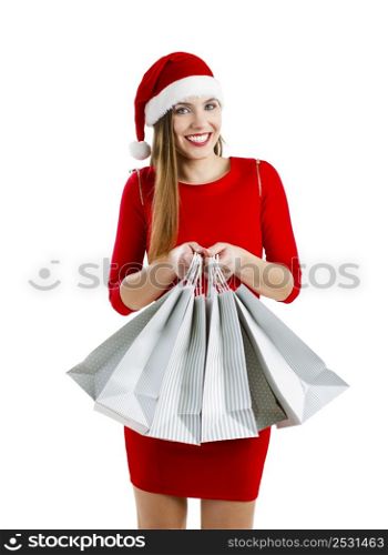 Beautiful and attractive woman with a santa hat holding shopping bags