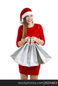 Beautiful and attractive woman with a santa hat holding shopping bags