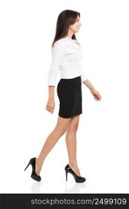 Beautiful and elegant hispanic business woman walking, over a white background