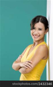 Beautiful and happy asian woman against a white wall in a green background