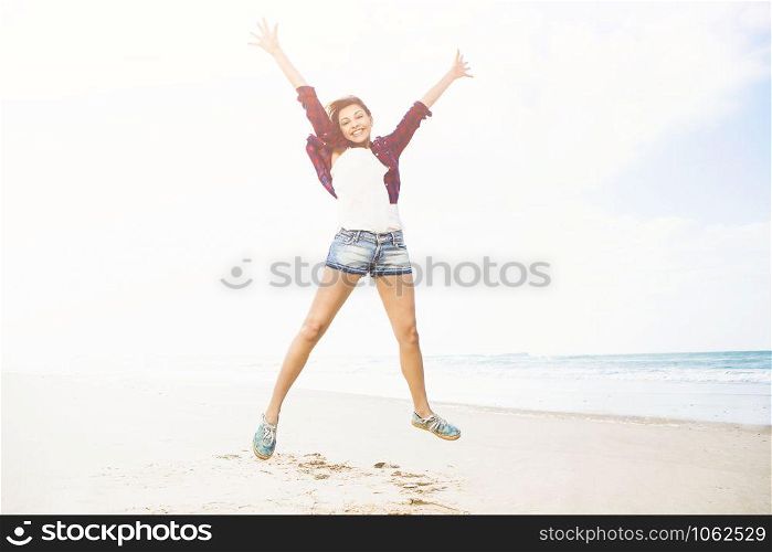 Beautiful and happy girl enjoying the day at the beach
