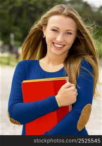 Beautiful and happy teenager student in the school