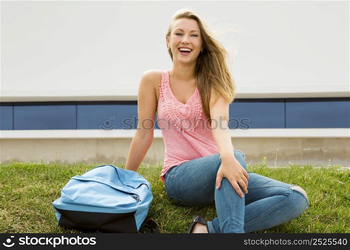 Beautiful and happy teenager studying in outdoor