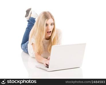 Beautiful and happy woman working with a laptop and astonished with something, isolated over white background