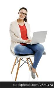 Beautiful and happy woman working with a laptop, isolated over white background