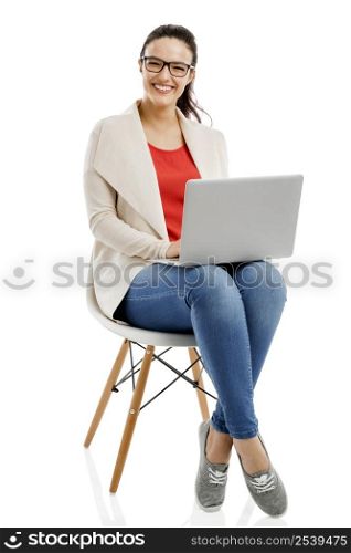 Beautiful and happy woman working with a laptop, isolated over white background