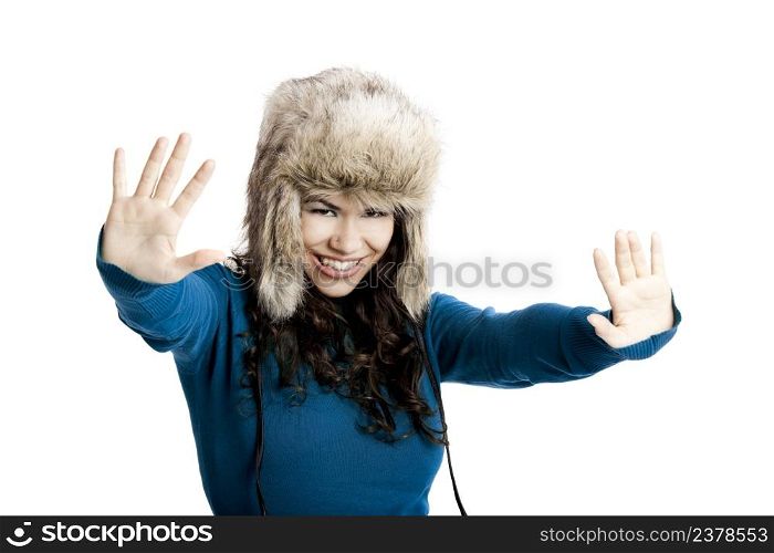 Beautiful and happy young woman isolated on white and wearing a fur hat