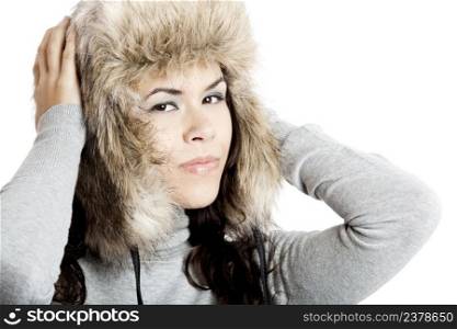 Beautiful and happy  young woman isolated on white and wearing a fur hat